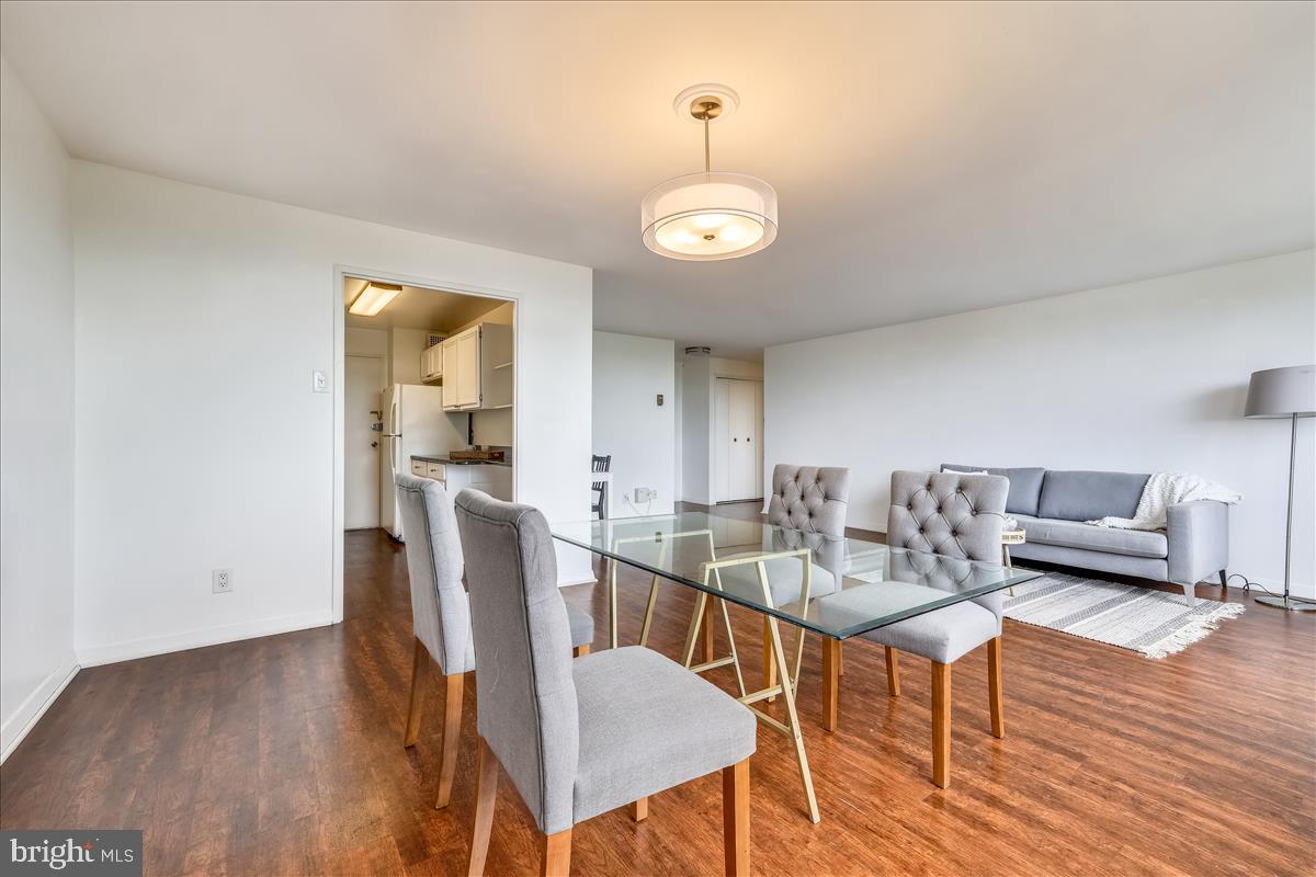 1900 Lyttonsville Road, Unit 1308 Silver Spring, MD 20910 - Photo 5 of 30 a view of a dining room with furniture and wooden floor