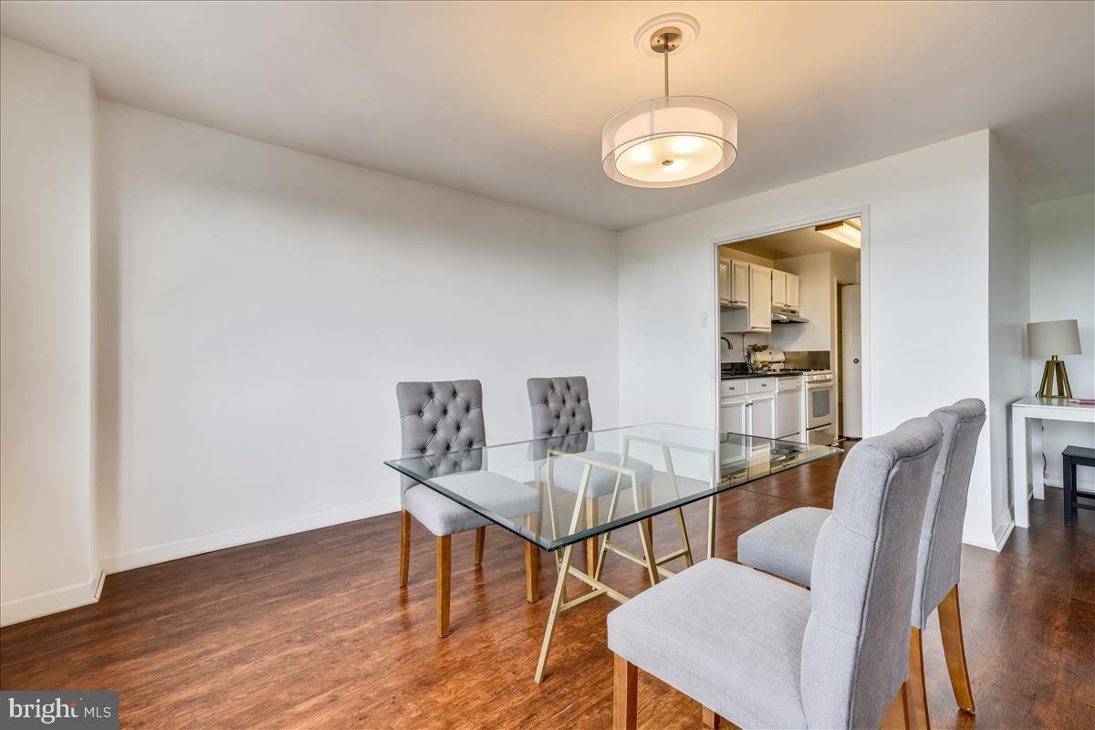 1900 Lyttonsville Road, Unit 1308 Silver Spring, MD 20910 - Photo 7 of 30 a view of a dining room with furniture and wooden floor
