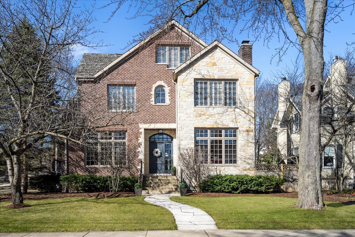 410 Cedar Street Winnetka, IL 60093 - Photo 1 of 57 a front view of a house with a yard and garage