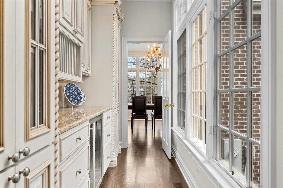 410 Cedar Street Winnetka, IL 60093 - Photo 14 of 57 a view of a hallway with wooden floor and furniture