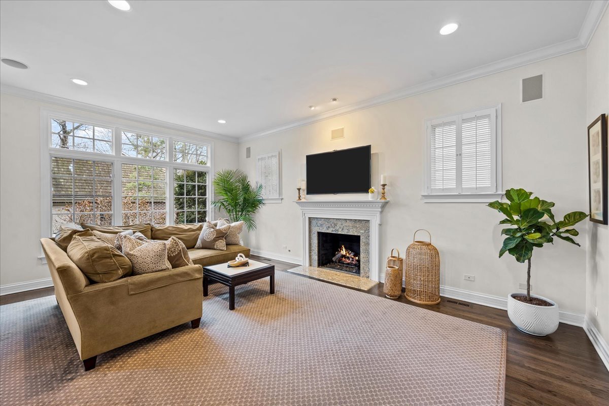 410 Cedar Street Winnetka, IL 60093 - Photo 22 of 57 a living room with furniture potted plant and a fireplace