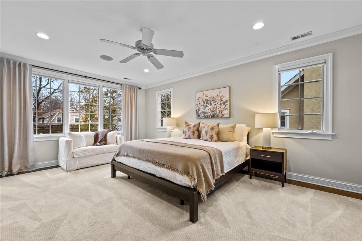 410 Cedar Street Winnetka, IL 60093 - Photo 27 of 57 a spacious bedroom with a bed and glass window