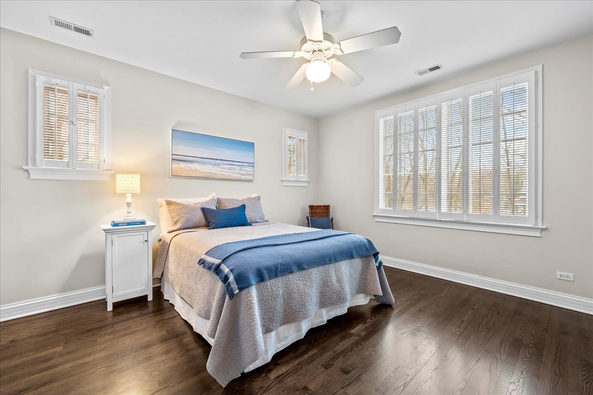 410 Cedar Street Winnetka, IL 60093 - Photo 32 of 57 a bedroom with a large bed chandelier and a window