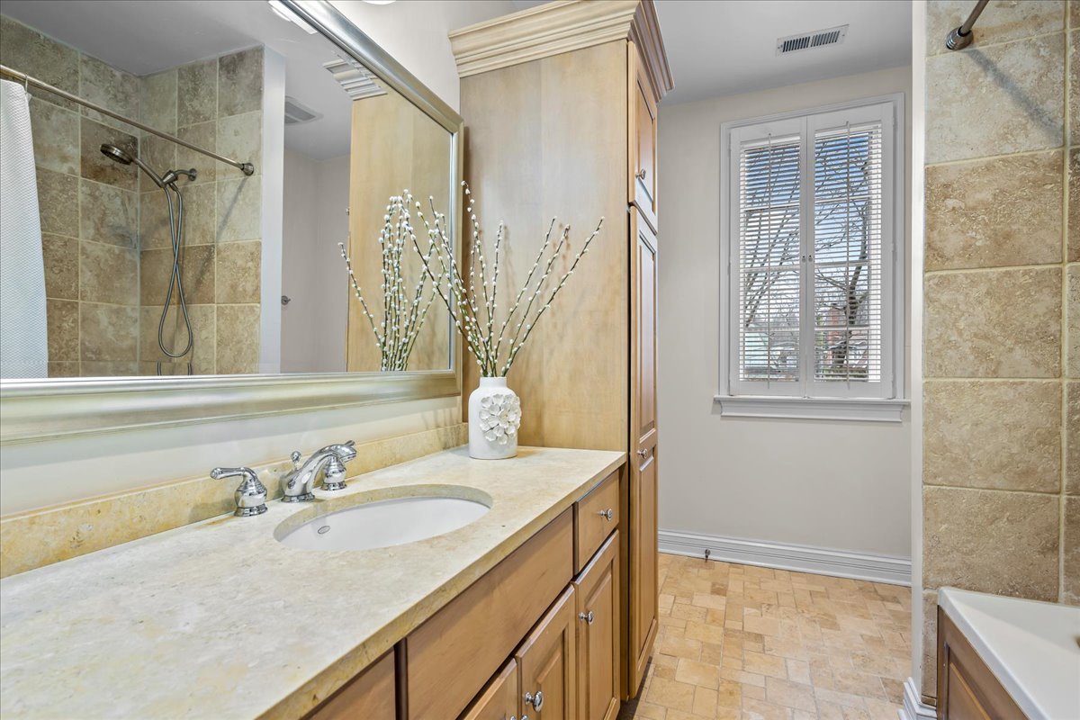 410 Cedar Street Winnetka, IL 60093 - Photo 33 of 57 a bathroom with a granite countertop sink and a mirror