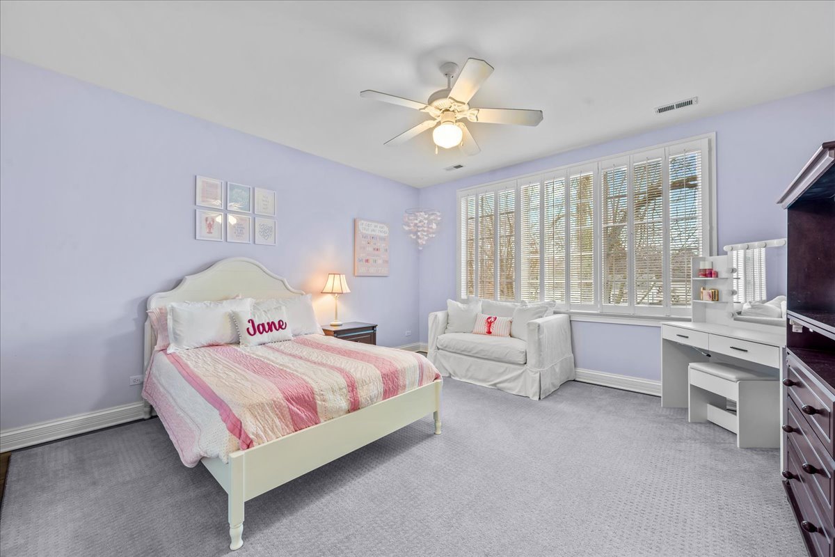 410 Cedar Street Winnetka, IL 60093 - Photo 37 of 57 a bedroom with a bed and a chandelier