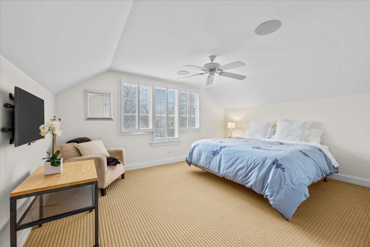 410 Cedar Street Winnetka, IL 60093 - Photo 40 of 57 a bedroom with a bed window and a flat screen tv