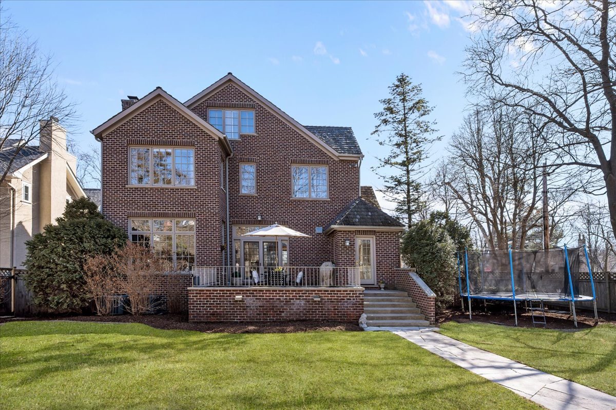410 Cedar Street Winnetka, IL 60093 - Photo 50 of 57 a front view of a house with a garden