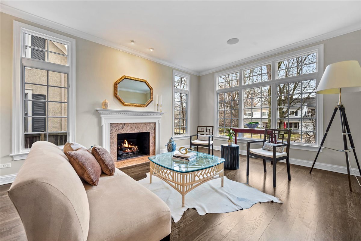 410 Cedar Street Winnetka, IL 60093 - Photo 8 of 57 a living room with furniture a fireplace a lamp and a large window