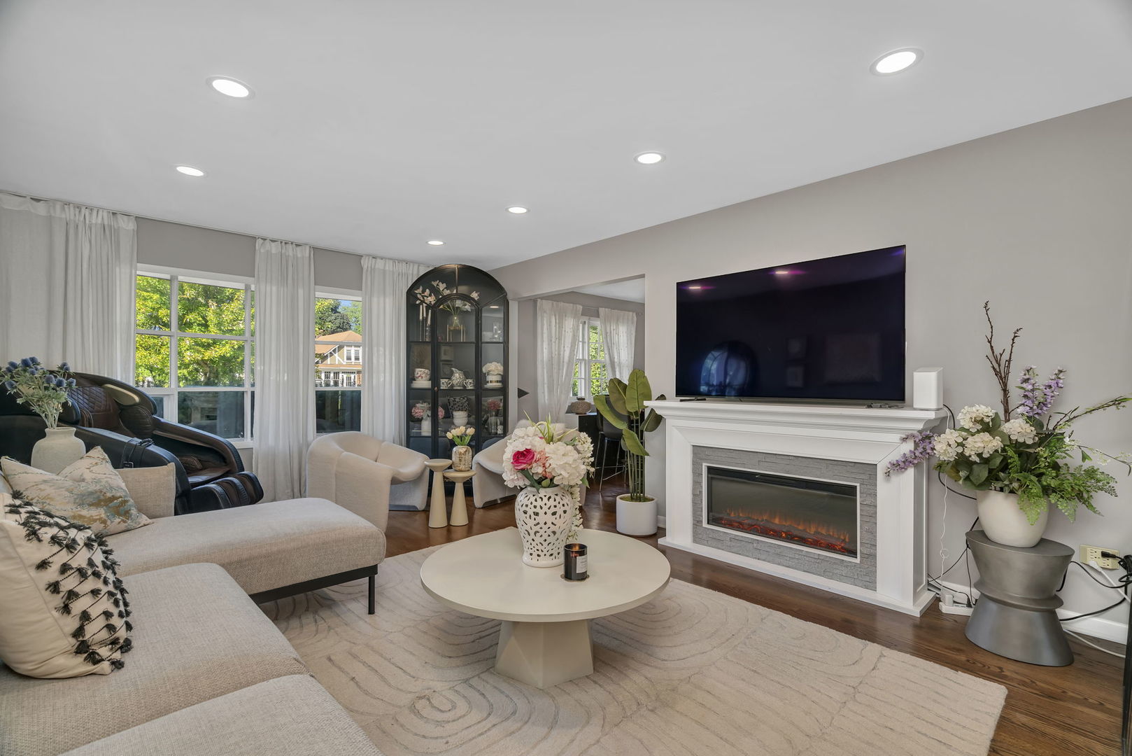 4217 Main Street Downers Grove, IL 60515 - Photo 2 of 31 a living room with furniture a flat screen tv and a fireplace