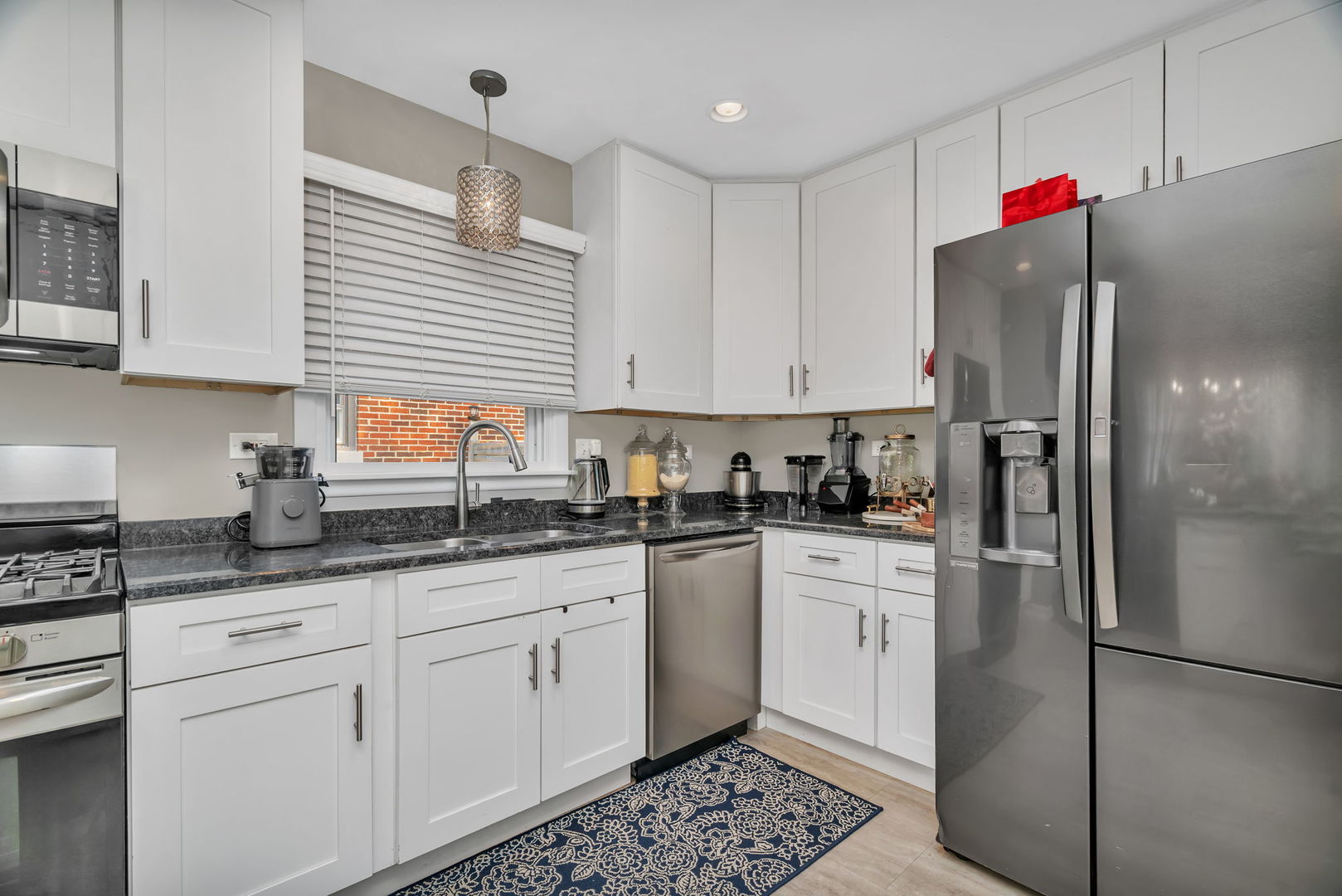 4217 Main Street Downers Grove, IL 60515 - Photo 7 of 31 a kitchen with stainless steel appliances granite countertop a refrigerator sink and cabinets