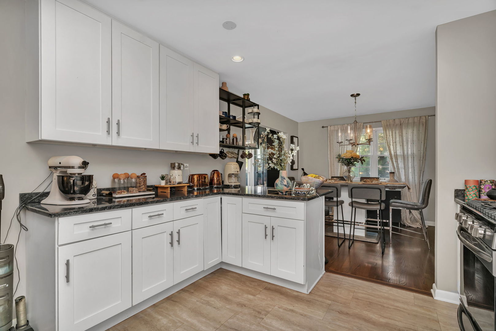 4217 Main Street Downers Grove, IL 60515 - Photo 9 of 31 a kitchen with white cabinets sink and dining table with wooden floor