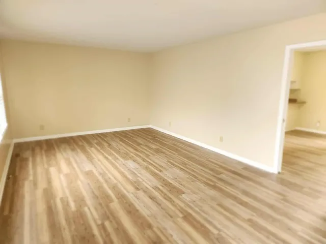 a view of wooden floor and brick walls
