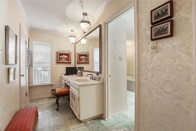 a bathroom with a tub sink and mirror