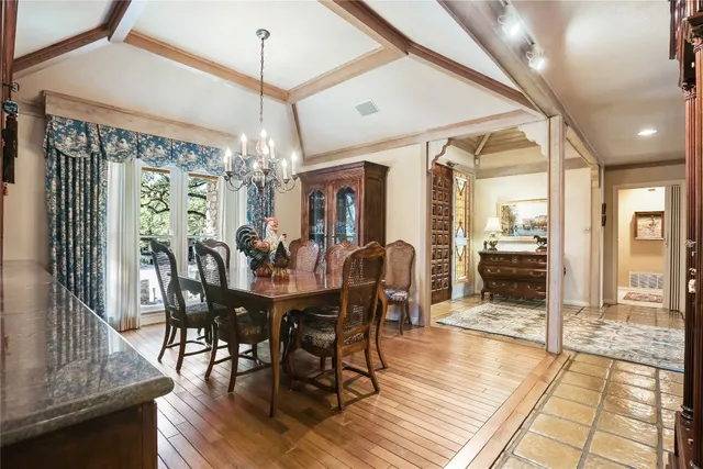 a view of a dining room with furniture wooden floor and chandelier