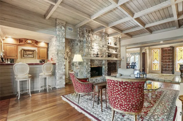 a living room with fireplace furniture and a chandelier