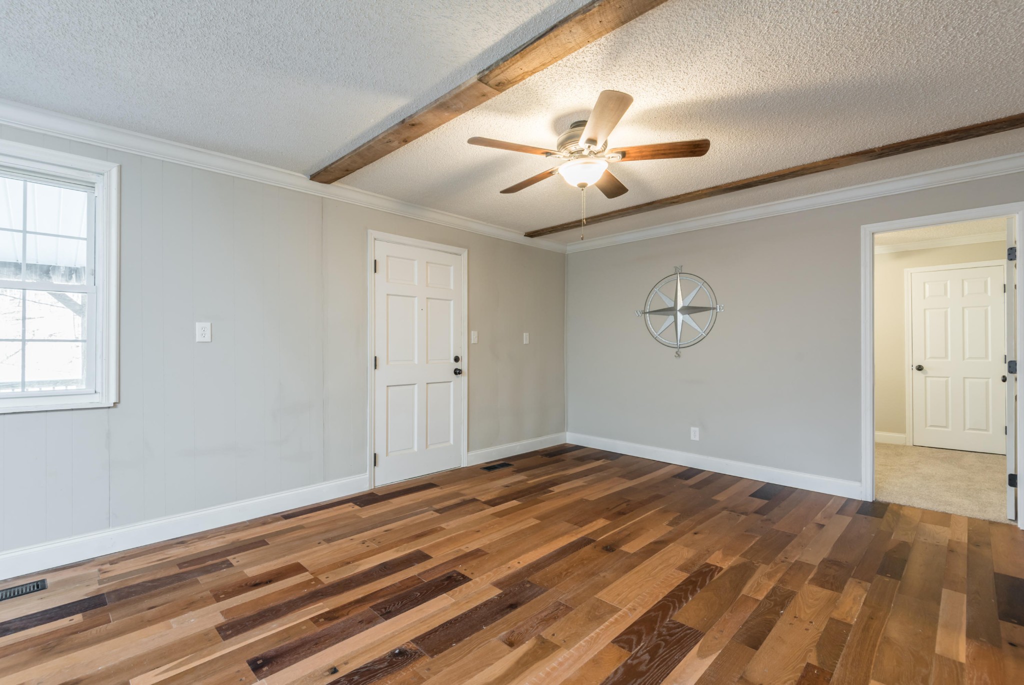 9825 Chestnut Ridge Road Heiskell, TN 37754 - Photo 13 of 32 an empty room with wooden floor fan and windows