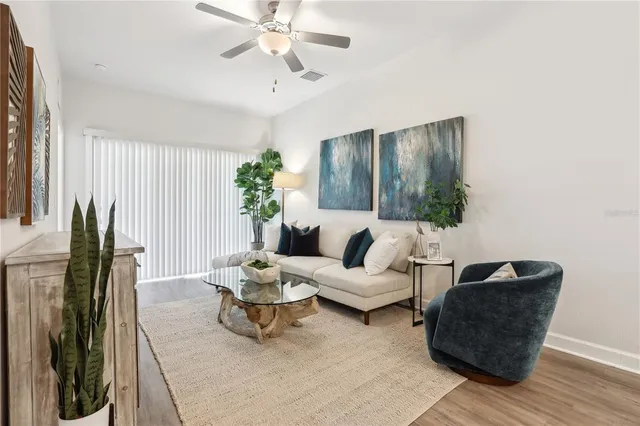a living room with furniture and wooden floor