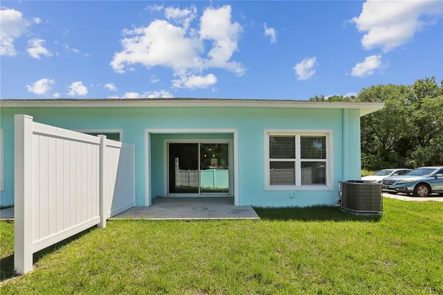 a view of a house with backyard and porch