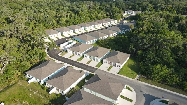 an aerial view of a house with a yard