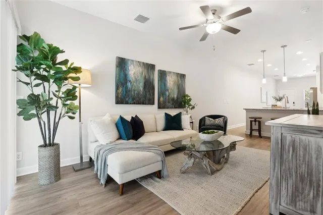 a living room with furniture and a potted plant
