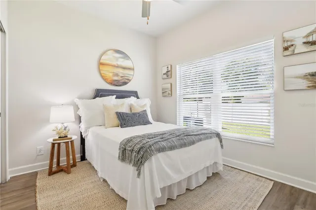 a bedroom with a bed and a window