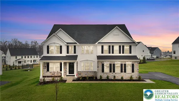 a front view of a house with a yard table and chairs