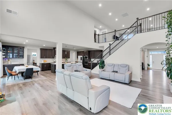 a living room with furniture a flat screen tv and a large window