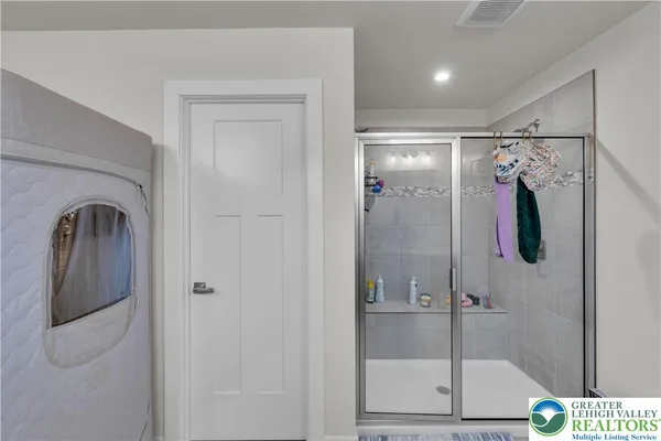 a bathroom with a sink toilet vanity and shower
