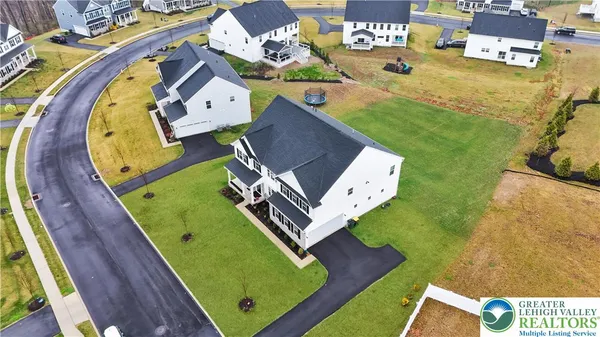 an aerial view of a house with a garden and pool