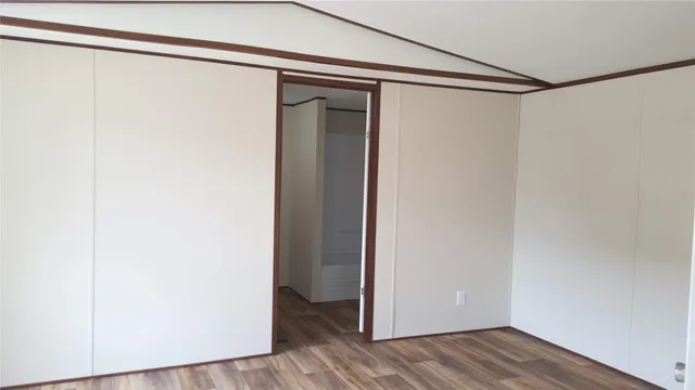 a view of a room with wooden floor