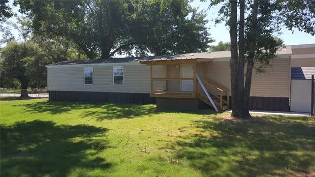 a view of house with yard