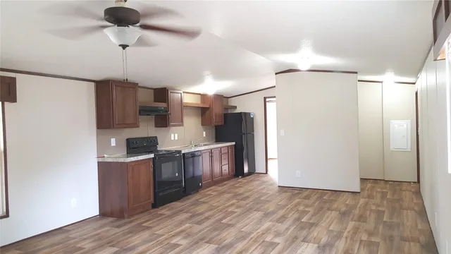 a kitchen with stainless steel appliances a refrigerator and a stove top oven