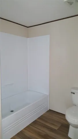 a bathroom with a shower and a toilet