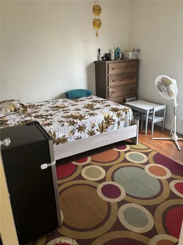 a view of a hallway to a livingroom with furniture and front door