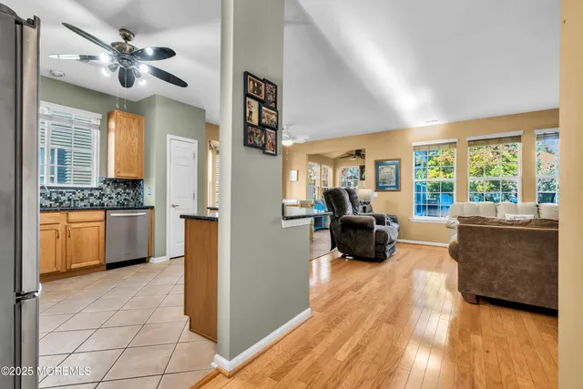 a kitchen with stainless steel appliances granite countertop a sink a stove and a refrigerator