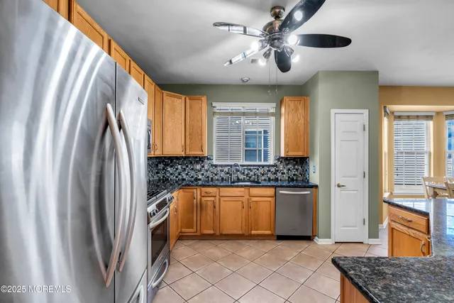 a view of a dining room with furniture and a chandelier