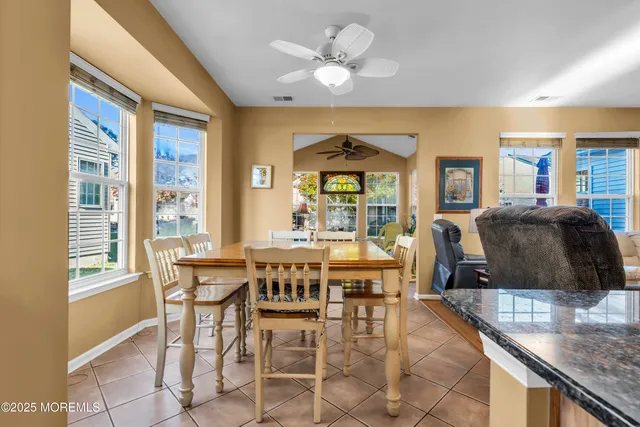 a large kitchen with a table and chairs