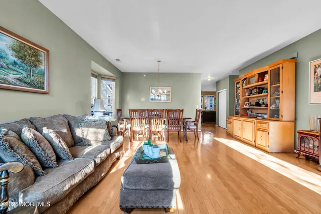 a dining room with furniture a chandelier and window