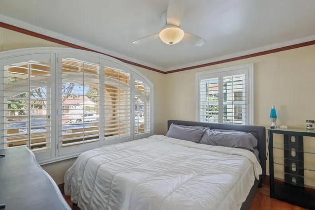 a bedroom with a large bed and a large window