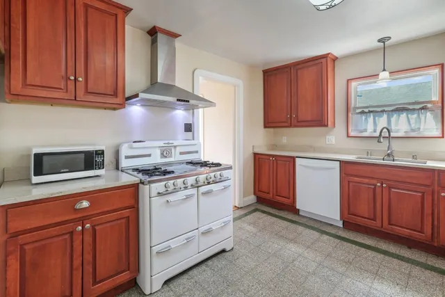 a kitchen with stainless steel appliances granite countertop a stove sink and cabinets