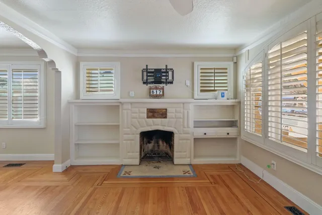 a living room with a fireplace and windows