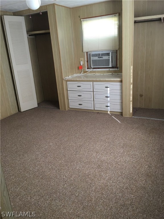 7744 Helen Road Bokeelia, FL 33922 - Photo 8 of 12 a room with a mirror and a dresser