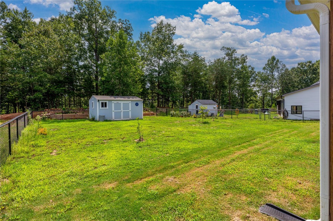 67 Sawblade Ridge Marietta, SC 29661 - Photo 26 of 37 A spacious lawn enclosed by chain-link fencing borders mature woodland borders.