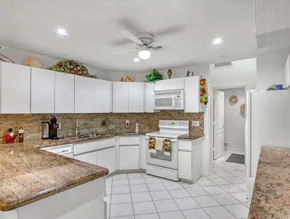a kitchen with a stove top oven sink and cabinets