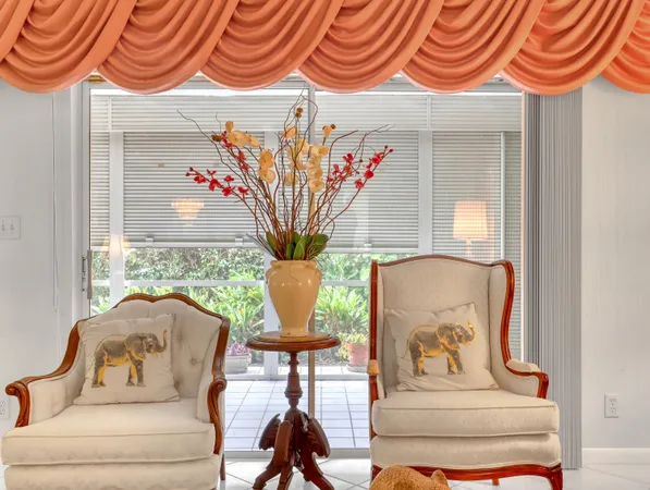 a living room with furniture and a large mirror