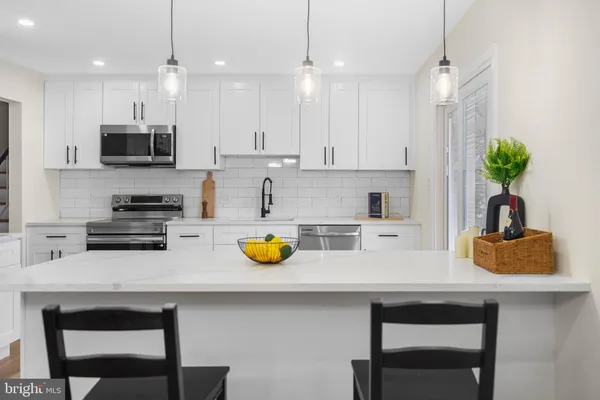 a kitchen with a sink a stove and cabinets