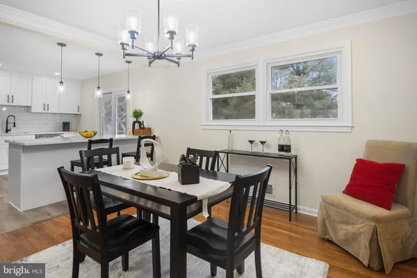 a view of a dining room with furniture and a chandelier