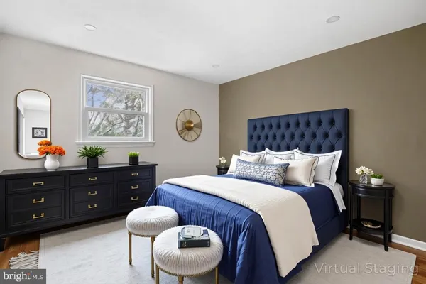 a bedroom with a bed and painting on the wall