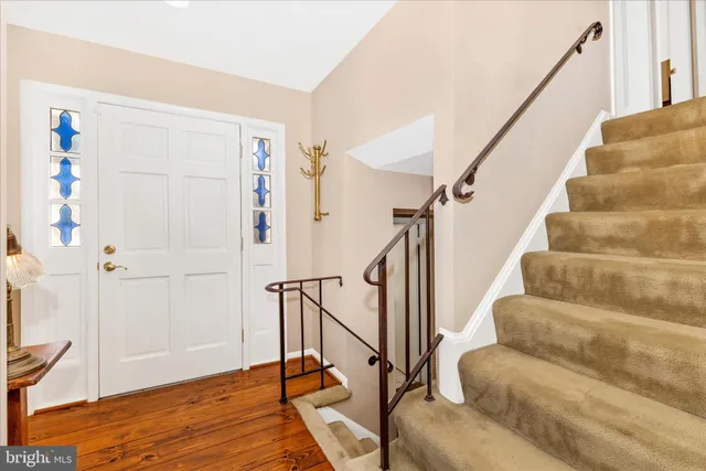 a view of entryway with wooden floor and stairs