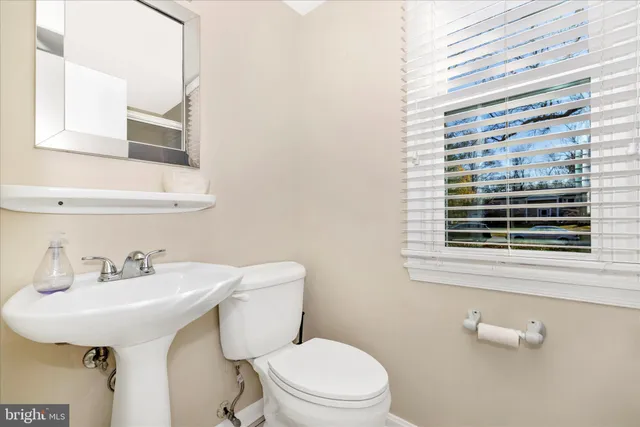 a bathroom with a sink a mirror and a toilet